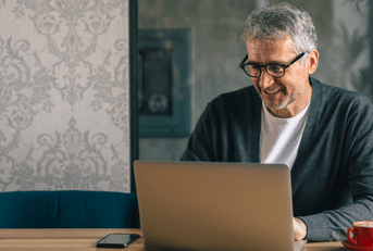 Man on laptop looking at banking options