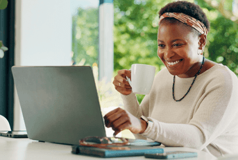 Woman checking her online banking on laptop