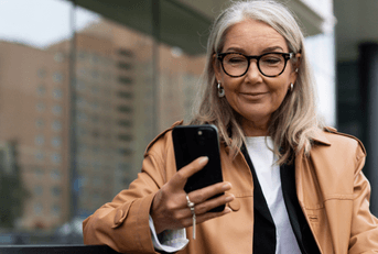 Woman sitting on bench checking online banking