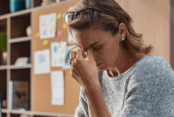 Woman looking at computer stressed out