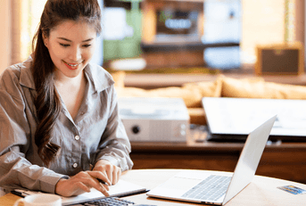 Woman using calculator and computer
