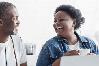 Retired couple on laptop reviewing expenses