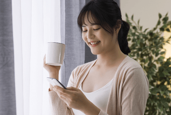 Woman checking savings account interest on phone
