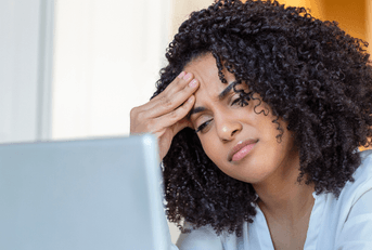 Woman looking confused at computer