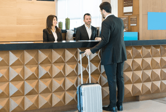 Man checking into hotel at front desk