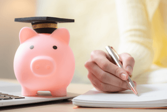 Woman playing tuition savings with piggy bank and laptop
