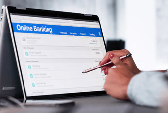 Woman checking online banking on tablet
