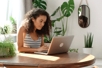 Woman at home checking banking on laptop