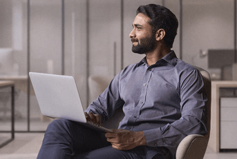 Young man thinking about his banking options with laptop