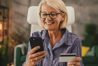 Woman in her 50's with credit card online shopping