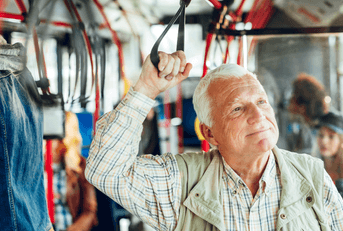 Senior man riding public bus