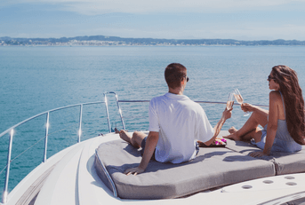 Wealthy couple drinking champagne on yacht