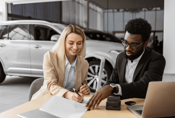 Woman signing papers to buy new car