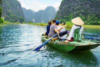 Travelers riding boat down river