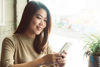 Woman smiling at phone