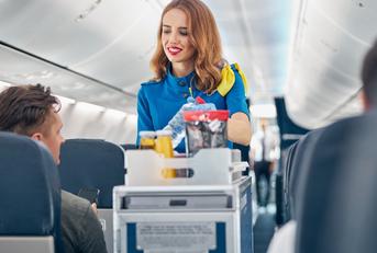 flight attendant serving food and drinks