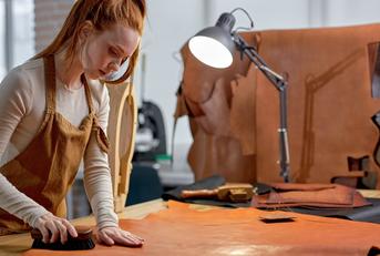 hardworking artisan concentrated on keeping leather in good shape