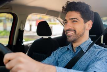 Smiling man driving a car