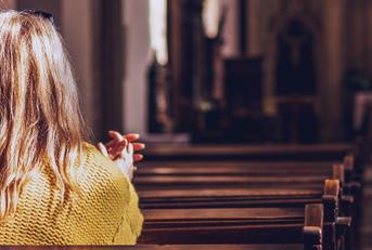 woman praying and meditating in church