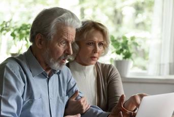 Shocked elderly spouses getting personal information hacked