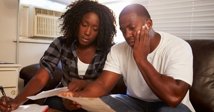 Stressed couple looking at paperwork