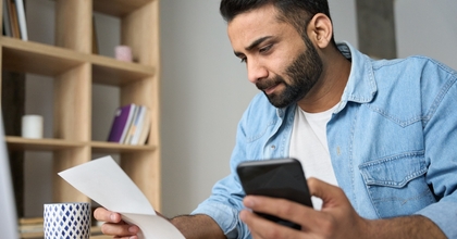 Man looking at check
