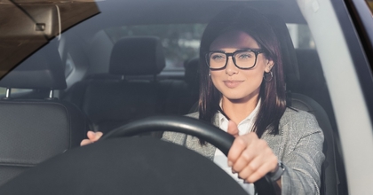 businesswoman looking ahead while driving car