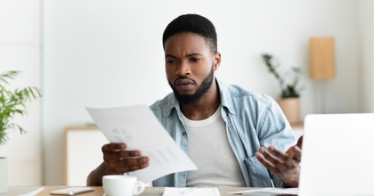 Man looking at bills