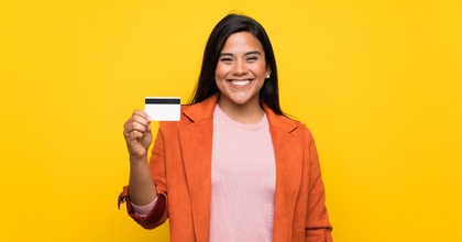 Young woman holding a credit card