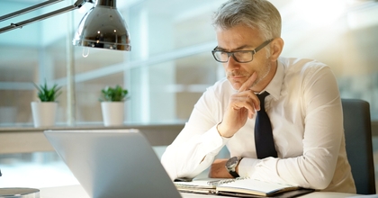 Businessman working on laptop in office