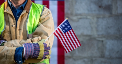 Worker holding American flag
