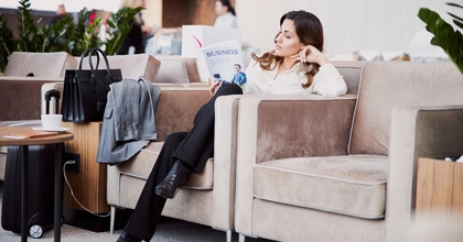 Woman reading book in hotel lounge