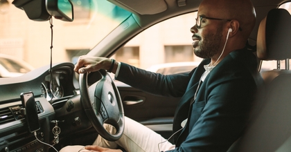 Man driving with headphones in