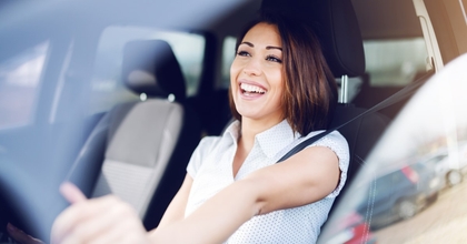 happy woman driving her car