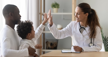 doctor, child, and father during a doctor visit