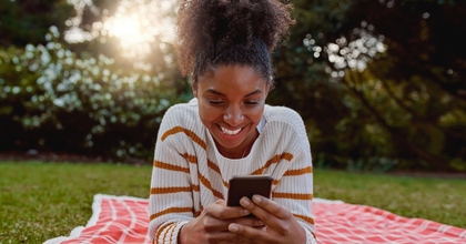 Happy woman looking at phone