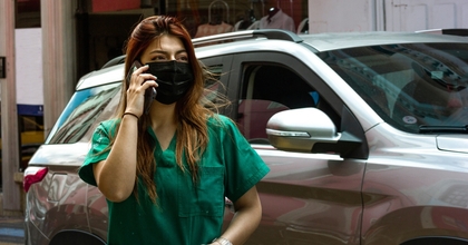 Nurse talking on the phone outside