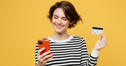 Smiling woman holding a phone and credit card