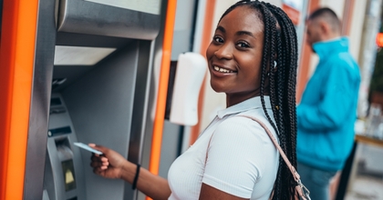 Smiling woman using ATM