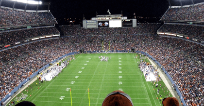 Fans are cheering at a football game.