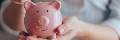 Someone holding a piggy bank