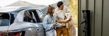 couple with dog at EV charging station
