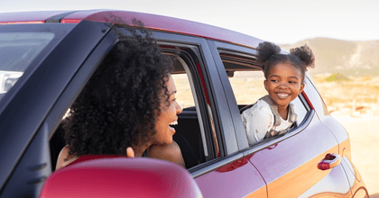 Happy mother and daughter in a car