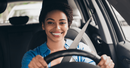 Smiling woman driving a car