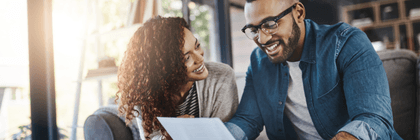 Smiling couple working on bills