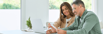 couple sitting at laptop with papers