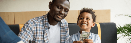 Father and son depositing cash