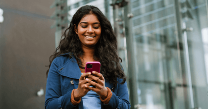 Woman looking at phone in city