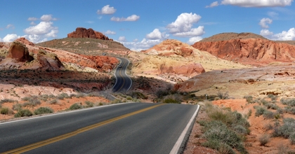 Nevada road cutting through desert mountains
