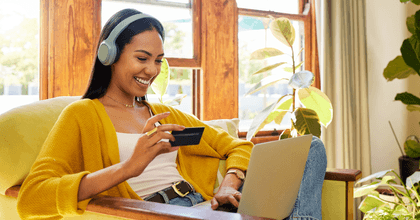 Girl on laptop with debit card